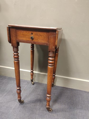Lot 715 - A 19th century mahogany work table on turned...