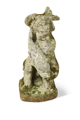 Lot 593 - A composite stone figure of a putto with fish, early 20th century