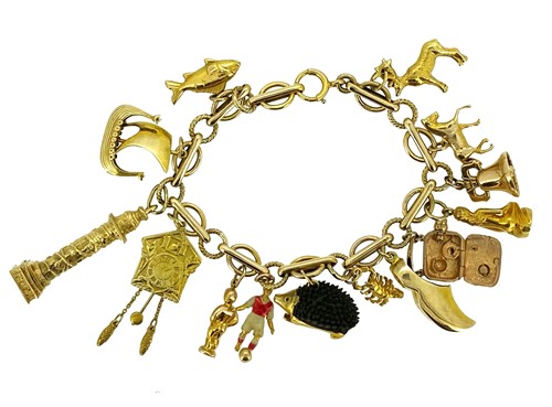 Lot 98 - A late 20th century charm bracelet with charms