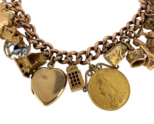 Lot 151 - A late 20th century rose gold charm bracelet with charms