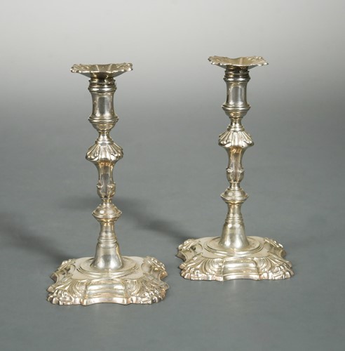 Lot 478 - A pair of George II cast silver tapersticks