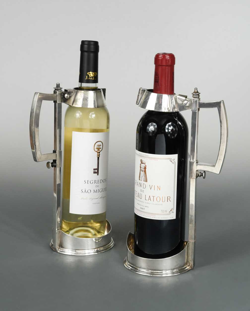 Lot 512 - A Victorian silver wine bottle pourer together with a silver plated example