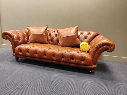 Lot 646 - A leather upholstered Chesterfield settee