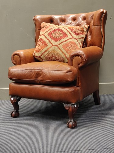 Lot 758 - A leather button upholstered armchair