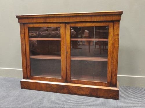 Lot 674 - A continental walnut bookcase enclosed by...