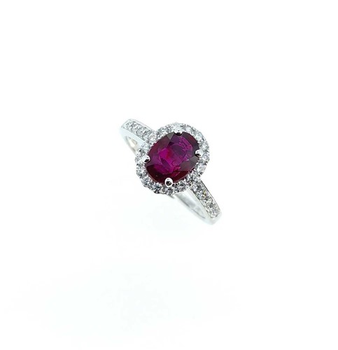 Lot 221 - An 18ct gold Burmese ruby and diamond halo style cluster ring