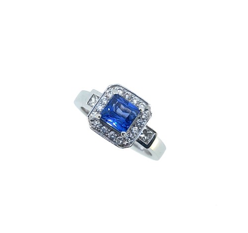 Lot 174 - An 18ct gold sapphire and diamond halo style ring