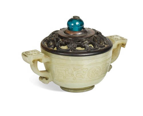 Lot 156 - A Chinese jadeite twin handled small archaic cup, late Qing Dynasty, circa 1900