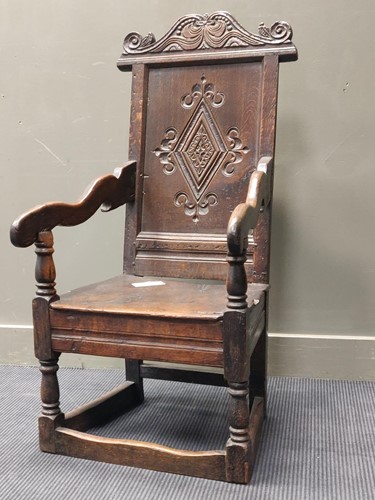 Lot 696 - A carved oak wainscot chair containing 17th...