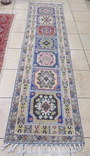 Lot 787 - A modern pale ground runner decorated with...
