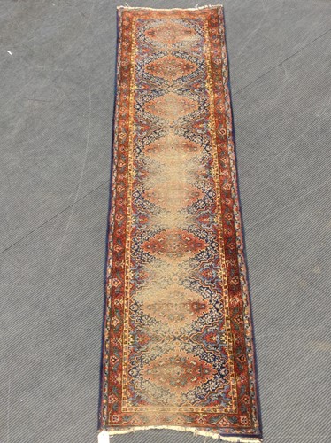 Lot 786 - A blue ground runner with red border enclosing...