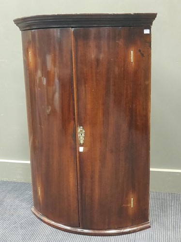 Lot 717 - A George III mahogany bowfronted hanging...