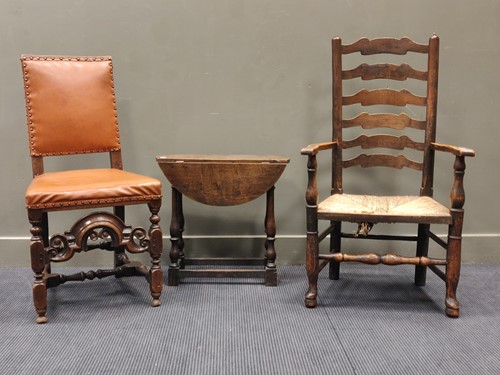 Lot 555 - An oak Carolean style leather seated dining...