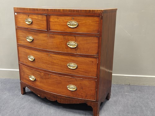 Lot 750 - An early 19th century bow front chest of...