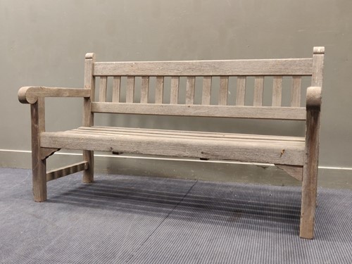 Lot 702 - A 20th century teak garden bench 90 x 154 x...