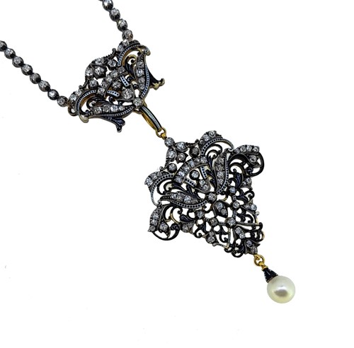 Lot 232 - Carlo Giuliano - A diamond and pearl necklace and brooch en suite