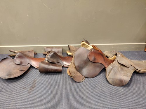 Lot 762 - A collection of various leather saddles to...
