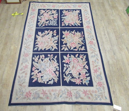 Lot 795 - A needle point floor covering decorated with...