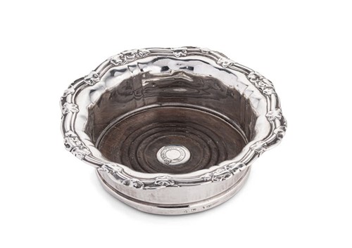 Lot 566 - A George IV silver bottle coaster