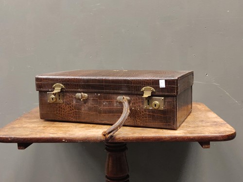 Lot 509 - A crocodile skin traveling case, 34 x 52 x 18cm