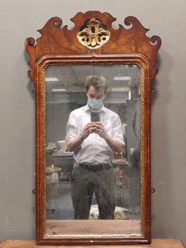 Lot 510 - A walnut and gilt highlighted wall mirror, 97...