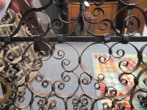 Lot 605 - Two similar wrought iron fire guards, circa 1900