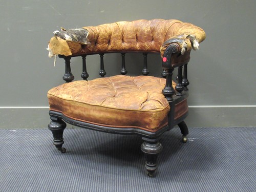 Lot 405 - A late Victorian ebonised library armchair