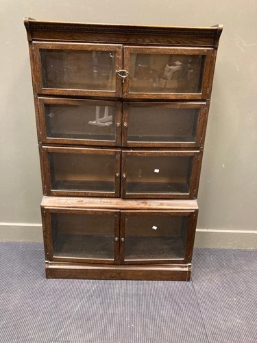 Lot 493 - An oak glazed four-sectional stacking bookcase,...