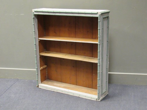 Lot 373 - A small pine painted open bookcase, with split...