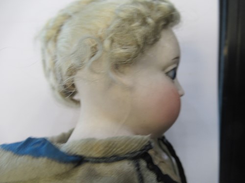 Lot 38 - A Victorian porcelain head doll, with blond...