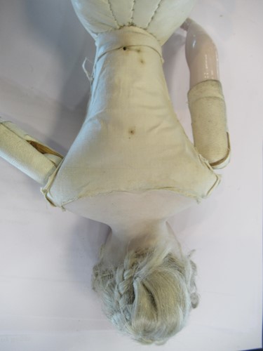 Lot 38 - A Victorian porcelain head doll, with blond...