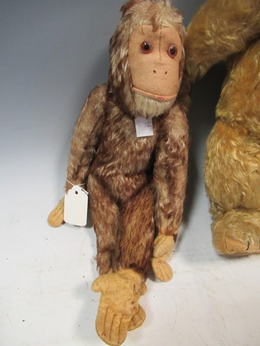 Lot 20 - A teddy bear, felt head doll, stuffed toy...