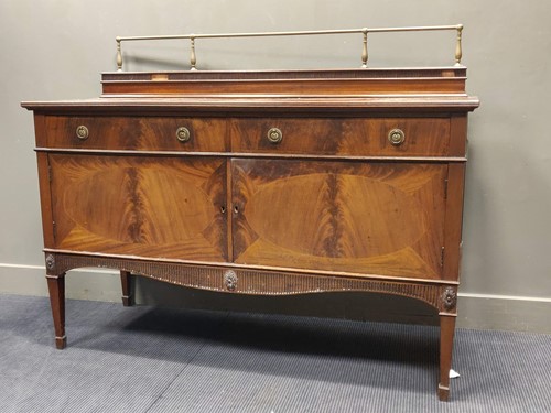 Lot 588 - A mahogany crossbanded side board with carved...