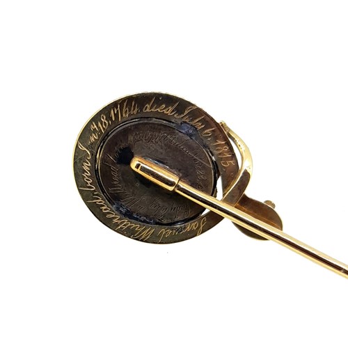 Lot 80 - An enamelled mourning stick pin, together with a cameo stick pin