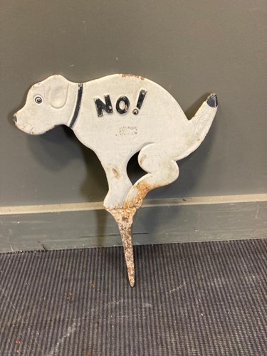 Lot 701 - A painted cast iron no fouling sign modelled...