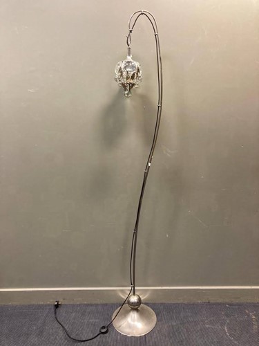 Lot 587 - A modern silvered standard lamp with moulded...