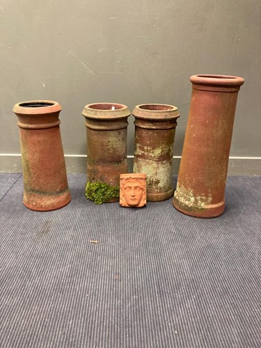 Lot 699 - Four terracotta chimney pots and a modern...