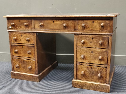 Lot 620 - An oak pedestal desk with black leather inset...