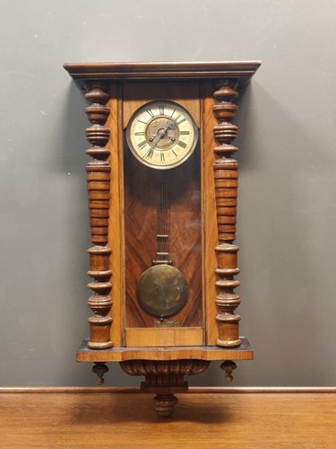 Lot 669 - A hardwood cased wall clock with glazed case...