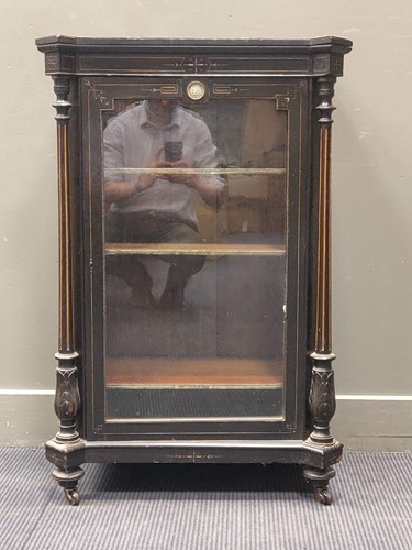 Lot 554 - An ebonised glazed cabinet, with carved...