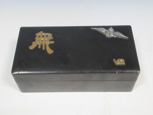 Lot 28 - A black laquered box decorated with RAF badge...