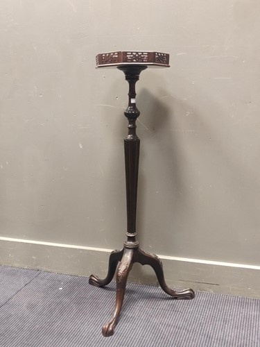 Lot 504 - A mahogany torchere in the Chippendale manner,...