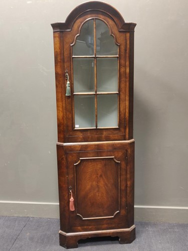 Lot 594 - A walnut corner cupbaord in the Queen Anne...