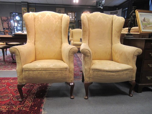 Lot 644 - A pair of wing back armchairs, early 20th...
