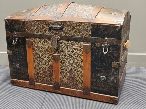 Lot 488 - An dome top metal and wooden banded trunk,...