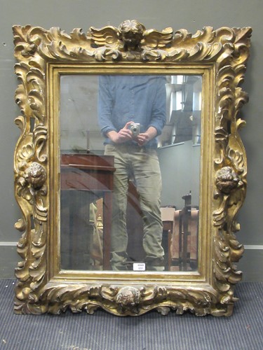 Lot 655 - A Florentine style carved giltwood mirror, 98...