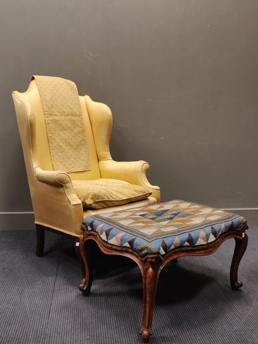 Lot 636 - An early 20th century wingback armchair...