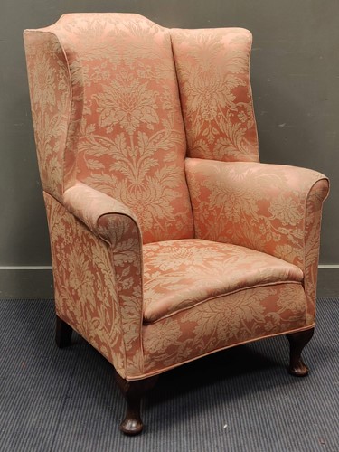 Lot 541 - An early 20th century wingback armchair