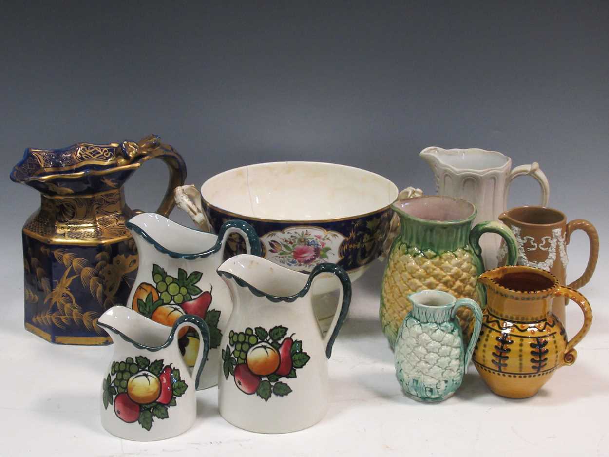 Lot 126 - A collection of various ceramic jugs to...