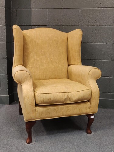 Lot 641 - A yellow upholstered armchair on cabriole legs